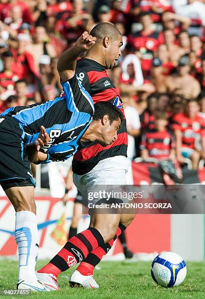 Flamengo's soccer player Adriano vies for the ball with Douglas of Gremio during their Brazilian Championship final date match at the Maracana...