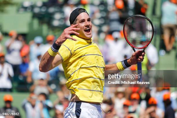 John Isner of the United States celebrates match point after defeating Alexander Zverev of Germany in the men's final on Day 14 of the Miami Open...