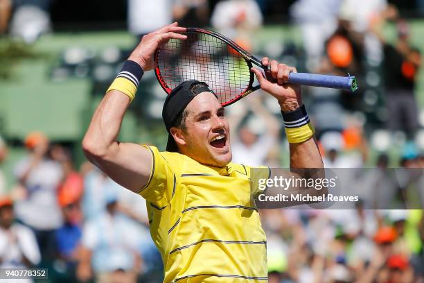 John Isner of the United States celebrates match point after defeating Alexander Zverev of Germany in the men's final on Day 14 of the Miami Open...