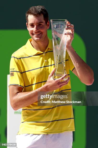 John Isner poses with the Butch Buchholz trophy after defeating Alexander Zverev of German during the men's final of the Miami Open Presented by Itau...