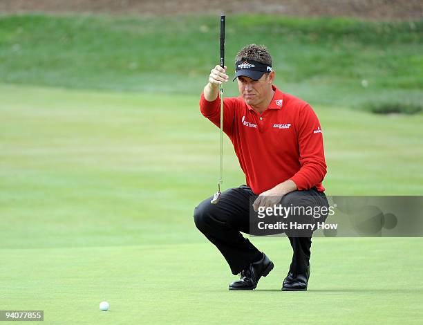 Lee Westwood of England lines up his putt on the third hole during the fourth round of the Chevron World Challenge at Sherwood Country Club on...