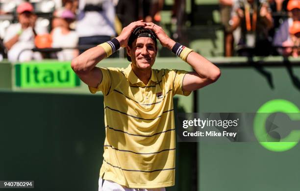 April 01: John Isner of the USA celebrates beating Alexander Zverev of Germany 6-7 6-4 6-4 in the men's final on Day 14 of the Miami Open Presented...