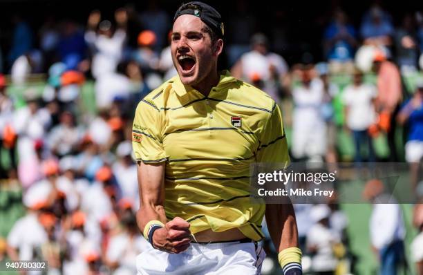 April 01: John Isner of the USA celebrates beating Alexander Zverev of Germany 6-7 6-4 6-4 in the men's final on Day 14 of the Miami Open Presented...