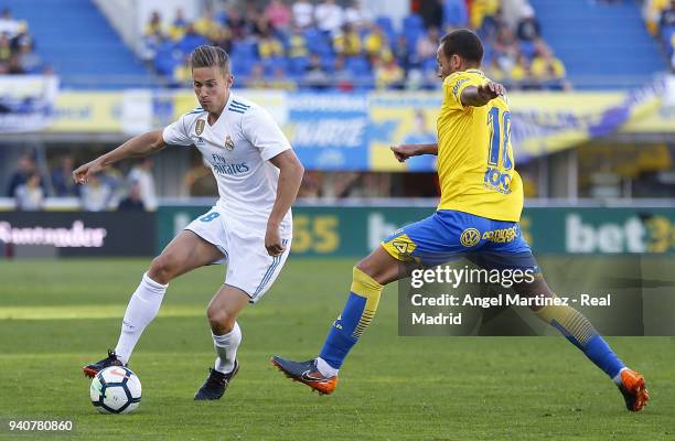 Marcos Llorente of Real Madrid competes for the ball with Javi Castellano of UD Las Palmas during the La Liga match between UD Las Palmas and Real...