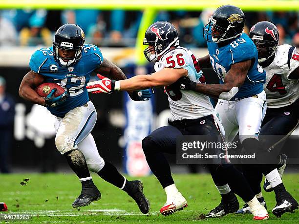 Brian Cushing of the Houston Texans attempts to tackle Maurice Jones-Drew of the Jacksonville Jaguars during the game at Jacksonville Municipal...