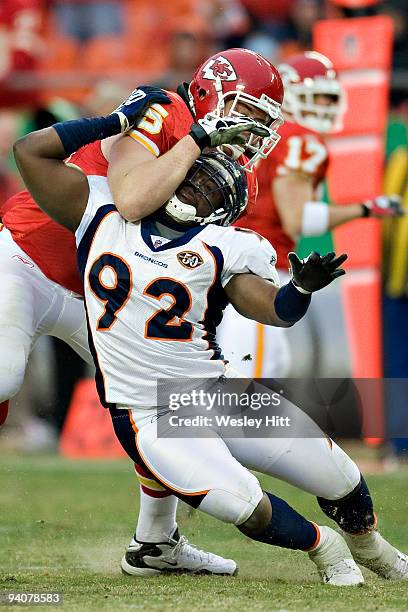 Elvis Dumervil of the Denver Broncos is blocked by Ryan O'Callaghan of the Kansas City Chiefs on December 6, 2009 in Kansas City, Missouri. The...