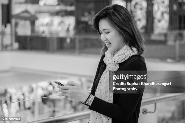 woman surprising what she found on mobile phone - suphat bhandharangsri stock pictures, royalty-free photos & images