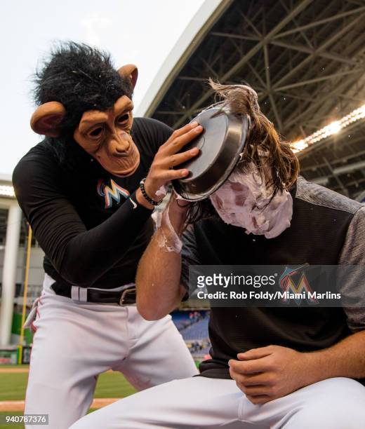 Dillon Peters of the Miami Marlins gets a pie in the face from the monkey after the game against the Chicago Cubs at Marlins Park on April 1, 2018 in...