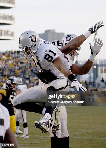 Chaz Schilens of the Oakland Raiders celebrates celebrates a fourth quarter touchdown with Tony Stewart while playing the Pittsburgh Steelers on...