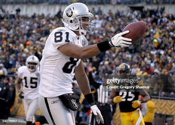 Chaz Schilens of the Oakland Raiders celebrates a fourth quarter touchdown while playing the Pittsburgh Steelers on December 6, 2009 at Heinz Field...