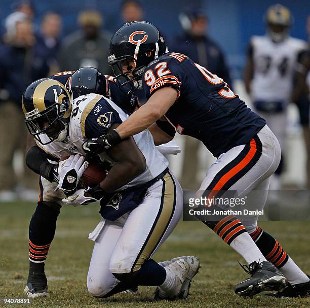 Jamar Williams and Hunter Hillenmeyer of the Chicago Bears bring down Randy McMichael of the St. Louis Rams at Soldier Field on December 6, 2009 in...