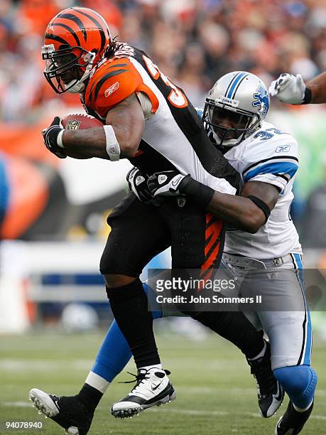 Cedric Benson of the Cincinnati Bengals breaks free from Anthony Henry of the Detroit Lions in their NFL game at Paul Brown Stadium December 6, 2009...