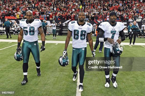 Defensive end Trent Cole, wide receiver Reggie Brown and quarterback Michael Vick of the Philadelphia Eagles walk out for the coin toss during the...