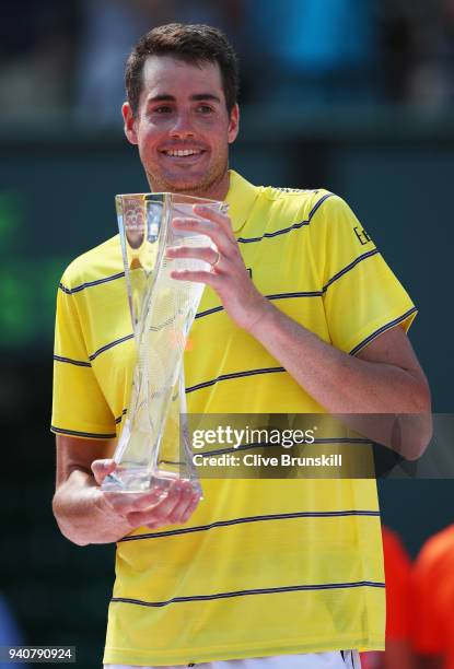 John Isner of the United States holds the Butch Bucholz trophy after his three set victory against Alexander Zverev of Germany in the mens final...