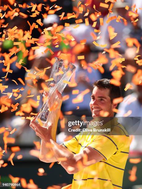 John Isner of the United States holds the Butch Bucholz trophy after his three set victory against Alexander Zverev of Germany in the mens final...