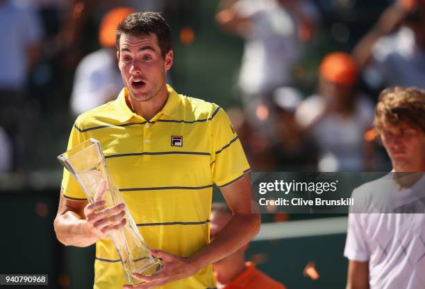 John Isner of the United States holds the Butch Bucholz trophy after his three set victory against Alexander Zverev of Germany in the mens final...