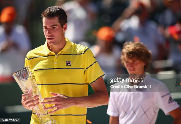 John Isner of the United States holds the Butch Bucholz trophy after his three set victory against Alexander Zverev of Germany in the mens final...