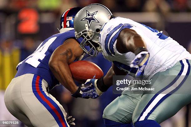 Ahmad Bradshaw of the New York Giants fumbles the ball as it is stripped by Jay Ratliff of the Dallas Cowboys at Giants Stadium on December 6, 2009...