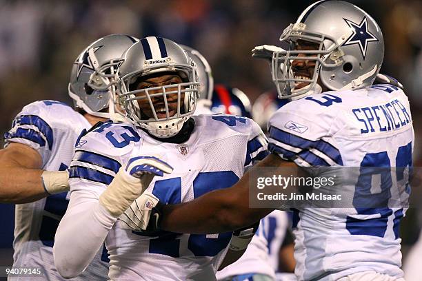 Gerald Sensabaugh and Anthony Spencer of the Dallas Cowboys celebrate after the Cowboys recovered a fumble on defense in the second quarter against...