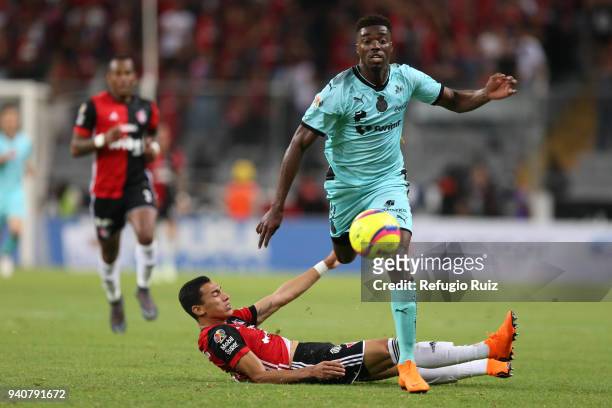 Ismael Govea of Atlas fights for the ball with Jorge Djaniny Tavares of Santos during the 13th round match between Atlas and Santos Laguna at Estadio...