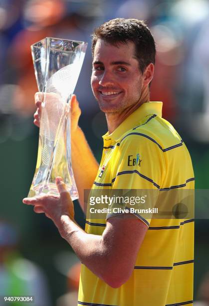 John Isner of the United States holds the Butch Bucholz trophy after his three set victory against Alexander Zverev of Germany in the mens final...