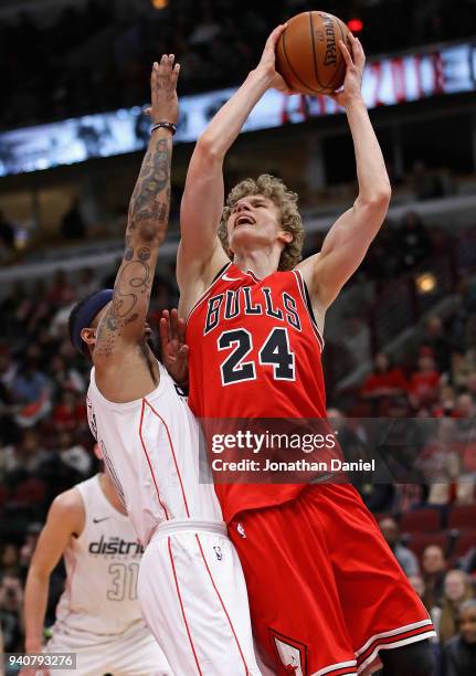 Lauri Markkanen of the Chicago Bulls puts up a shot against Mike Scott of the Washington Wizards on his way to a game-high 23 points at the United...