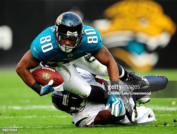 Mike Thomas of the Jacksonville Jaguars is tackled by Brice McCain of the Houston Texans during the game at Jacksonville Municipal Stadium on...