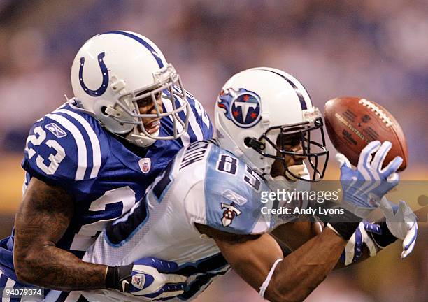 Nate Washington of the Tennessee Titans catches a pass while defended by Tim Jennings of the Indianapolis Colts at Lucas Oil Stadium on December 6,...