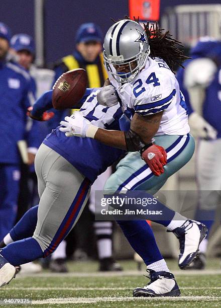 Marion Barber of the Dallas Cowboys fumbles the ball as he is hit by Mathias Kiwanuka of the New York Giants in the second quarter at Giants Stadium...