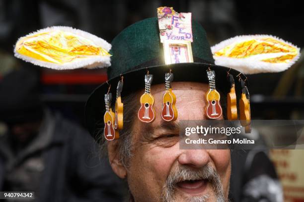 Musician Wild Bill Fisher adds rabbit ears and guitars to his St. Patrick's Day Hat for Easter Sunday where hundreds of homeless and near-homeless...