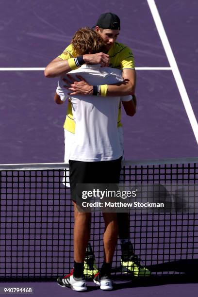 John Isner is congratulated by after their match Alexander Zverev of German during the men's final of the Miami Open Presented by Itau at Crandon...