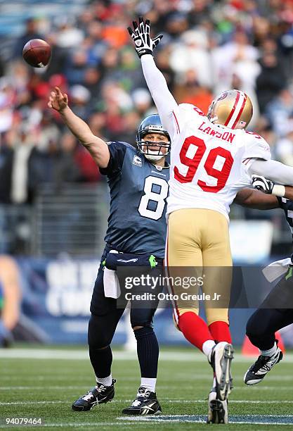 Quarterback Matt Hasselbeck of the Seattle Seahawks passes against Manny Lawson of the San Francisco 49ers on December 6, 2009 at Qwest Field in...