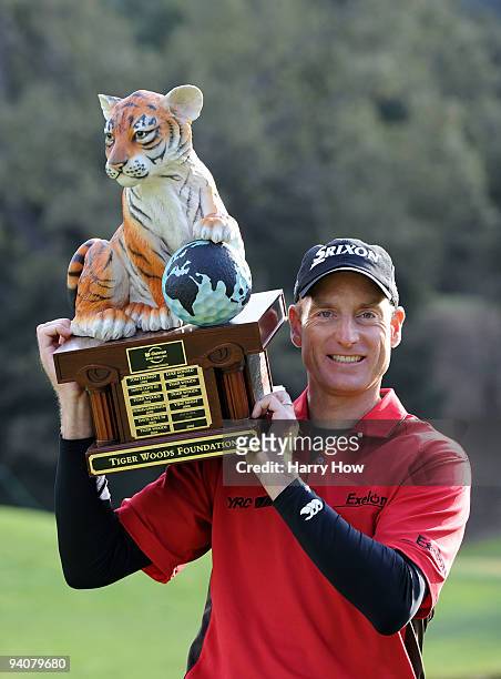 Jim Furyk poses with the trophy on the 18th hole after finishing 13 under par for the tournament during the fourth round of the Chevron World...