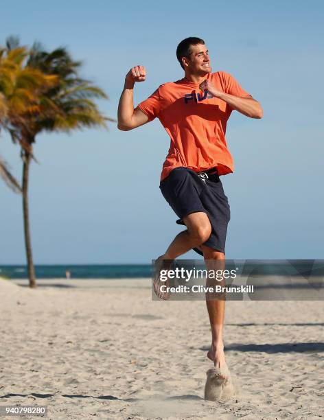 John Isner of the United States jumps for joy on Crandon Park Beach after his three set victory against Alexander Zverev of Germany in the mens final...