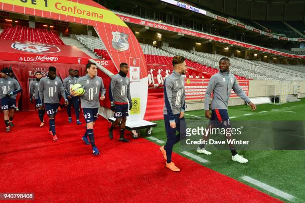 Following a recent pitch invasion, no supporters are allowed into the stadium, as Ibrahim Amadou of Lille leads his teamout to warm up before the...