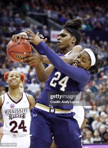 Teaira McCowan of the Mississippi State Lady Bulldogs and Arike Ogunbowale of the Notre Dame Fighting Irish battle for the ball during the first...