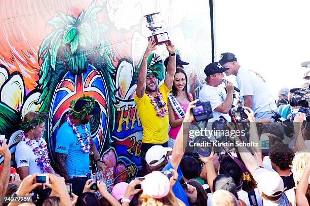 Joel Parkinson of Australia lifts his winner's trophy during the prize giving of the O'Neill World Cup of Surfing on December 6, 2009 in Sunset...