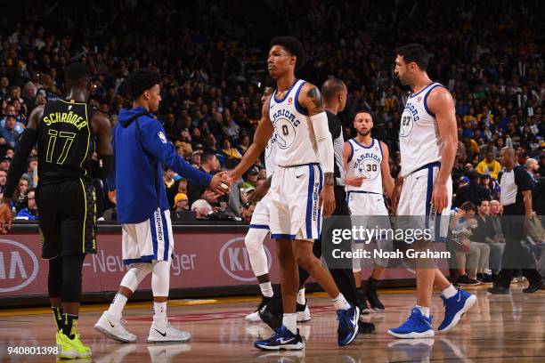 Patrick McCaw of the Golden State Warriors high fives teammates during the game against the Atlanta Hawks on March 23, 2018 at ORACLE Arena in...