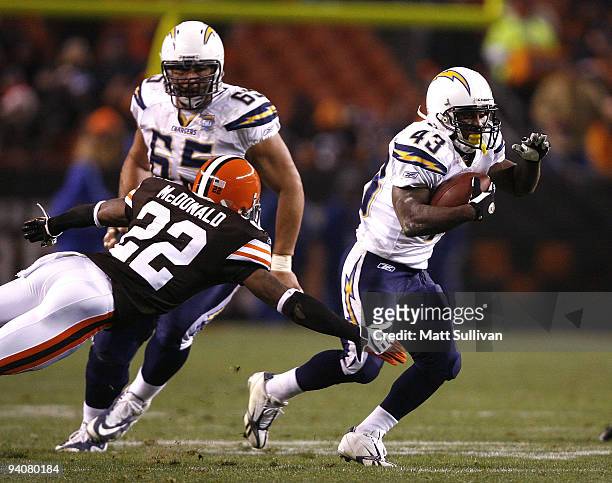 Darren Sproles of the San Diego Chargers runs by Brandon McDonald of the Cleveland Browns at Cleveland Browns Stadium on December 6, 2009 in...