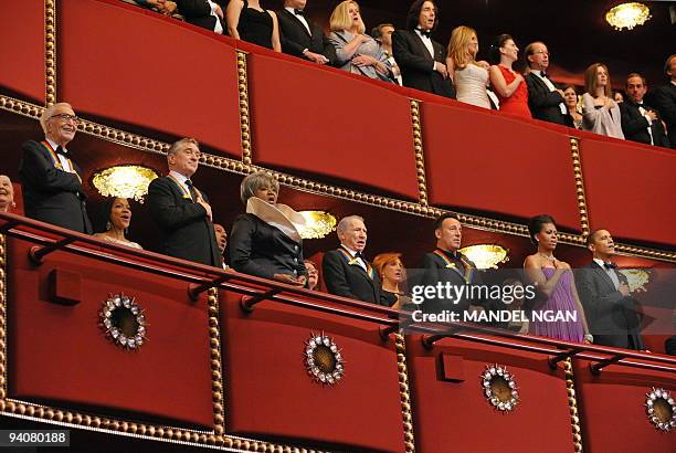 President Barack Obama and First Lady Michelle Obama listen to the national anthem during the 32nd Annual Kennedy Center Honors with recipients...