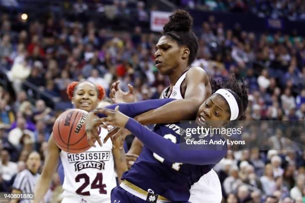 Teaira McCowan of the Mississippi State Lady Bulldogs and Arike Ogunbowale of the Notre Dame Fighting Irish battle for the ball during the first...