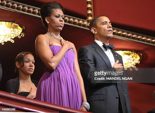 President Barack Obama and First Lady Michelle Obama listen to the national anthem during the 32nd Annual Kennedy Center Honors December 6, 2009 at...