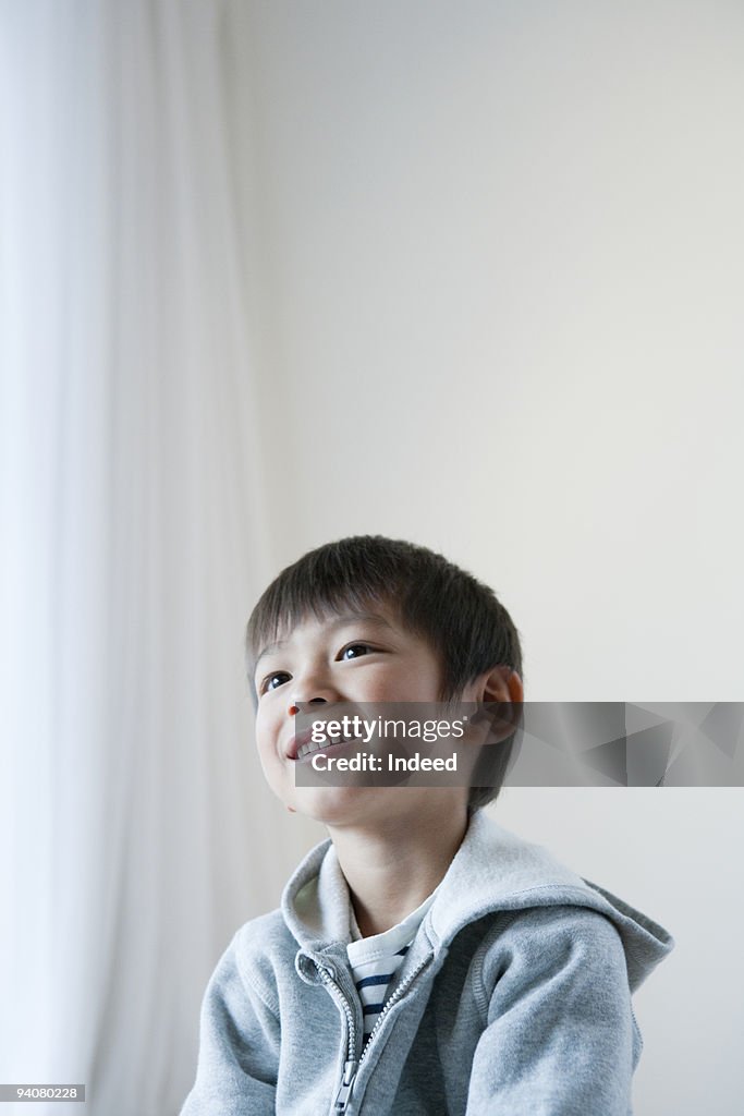 Portrait of boy, looking up, smiling