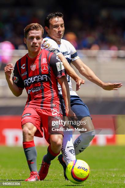 Fernando Gonzalez of Necaxa fights for the ball with Erick Torres of Pumas during the 13th round match between Pumas UNAM and Necaxa as part of the...