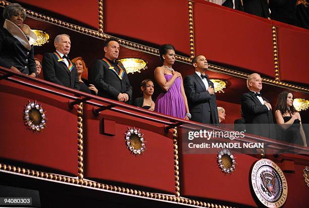 President Barack Obama and First Lady Michelle Obama with Vice President Joe Biden and his daughter Ashley listen to the national anthem during the...