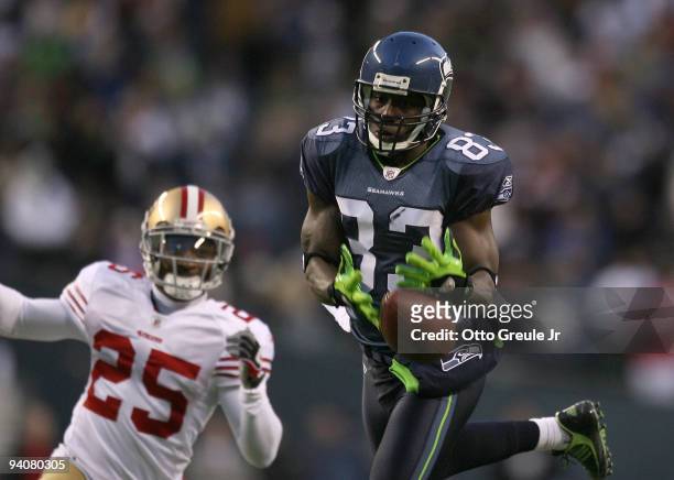 Wide receiver Deion Branch of the Seattle Seahawks just misses making a catch in the fourth quarter against Tarell Brown the San Francisco 49ers on...