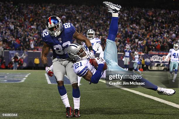 Mike Jenkins of the Dallas Cowboys intercepts a pass in the endzone against Mario Manningham of the New York Giants in the third quarter at Giants...