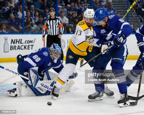 Goalie Andrei Vasilevskiy and Anton Stralman of the Tampa Bay Lightning look for the puck against Nick Bonino of the Nashville Predators during the...