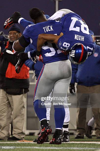 Justin Tuck and Domenik Hixon of the New York Giants celebrate after Hixon scored on a 79-yard punt return in the fourth quarter against the Dallas...