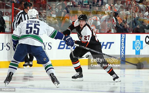 Mike Pyorala of the Philadelphia Flyers skates against Shane O'Brien of the Vancouver Canucks on December 3, 2009 at Wachovia Center in Philadelphia,...